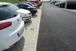  v.l.n.r.: Ein Mix aus wasserdurchlässigen Materialien prägt den neuen Mitarbeiterparkplatz der Firma Stihl in Waiblingen. Rechts die Fahrspur mit Drainasphalt befestigt, links daneben ein haufwerksporiges BetonpflasterDank seiner feinen Oberflächenstruktur wirkt der wasserdurch-lässige Pflasterbelag optisch sehr edelLediglich bei Starkregen gelangt überschüssiger Niederschlag über ein Rigolensystem in ein offenes Rückhaltebecken und dann zum ErbachParkierungsanlage: hier wurden die Stellflächen mit der klassischen Variante des Pflastersystems Cityblock befestigt 